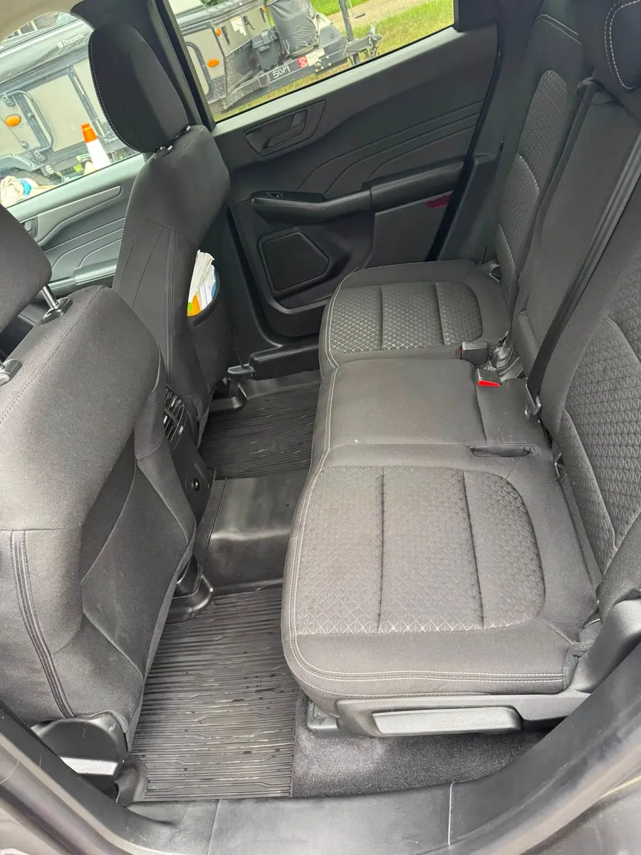 The same rear vehicle seating after detailing with a clean carpet and seats