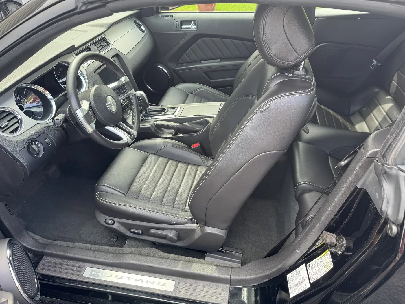 A freshly detailed black leather Mustang interior